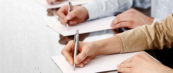 Row of writing human hands