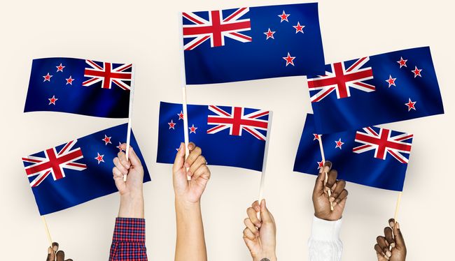 Hands waving flags of New Zealand