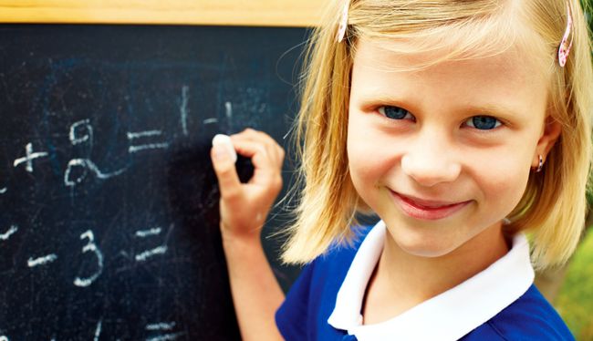 schoolgirl decides on a blackboard mathematical tasks